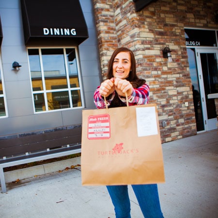 https://www.candyboxmarketing.com/wp-content/uploads/2021/12/Turtle-Jacks-Photoshoot-Vanessa-Holding-Bag.jpg