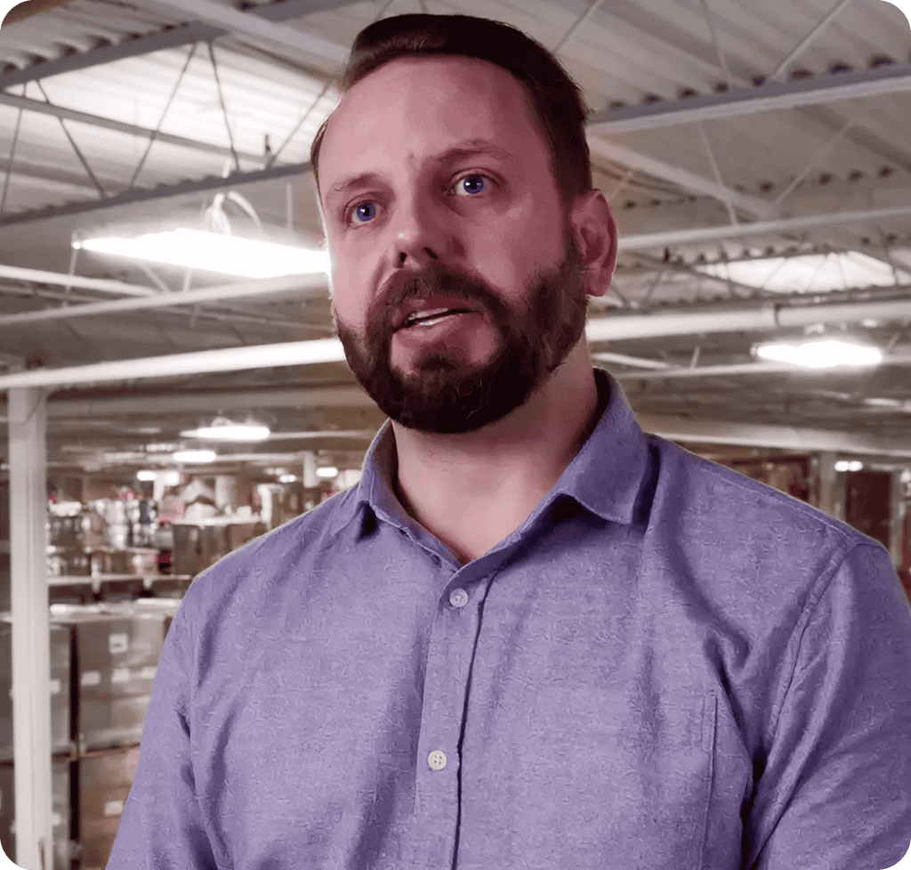 Warehouse manager explaining logistics in a warehouse setting.